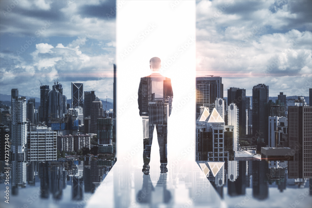 Abstract image of businessman standing on city background. Success, growth and future concept. Double exposure. Abstract image of businessman standing on city background. Success, growth and future concept. Double exposure.