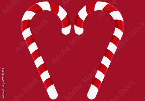 Bastones de caramelo navideño en fondo rojo.