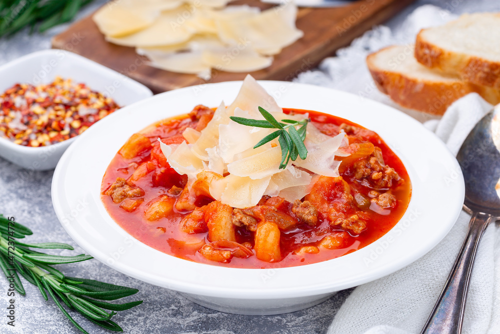 Minestrone soup with cavatappi pasta, beans and vegetables with crispy bread, horizontal, closeup Minestrone soup with cavatappi pasta, beans and vegetables with crispy bread, horizontal, closeup