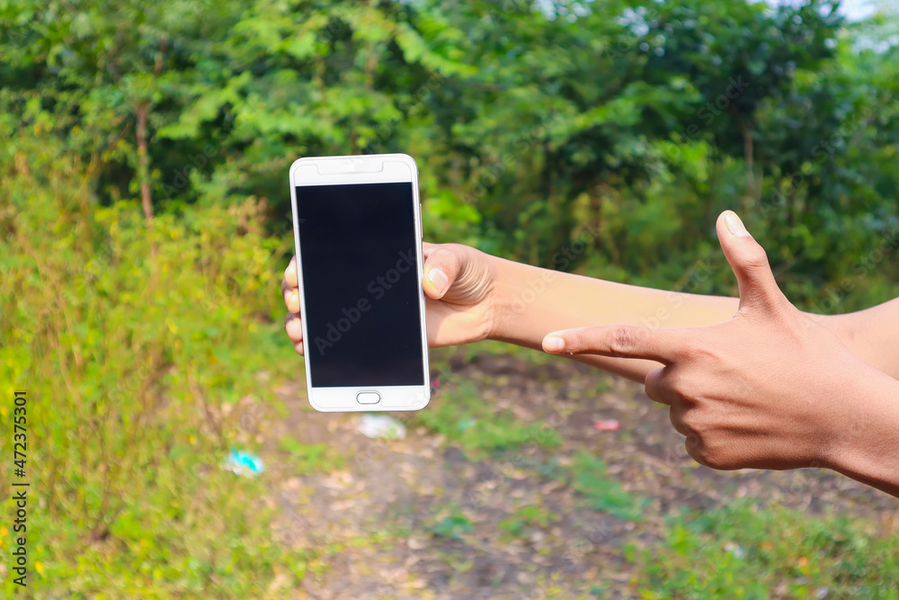 Indian school boy showing smartphone screen. online education concept.