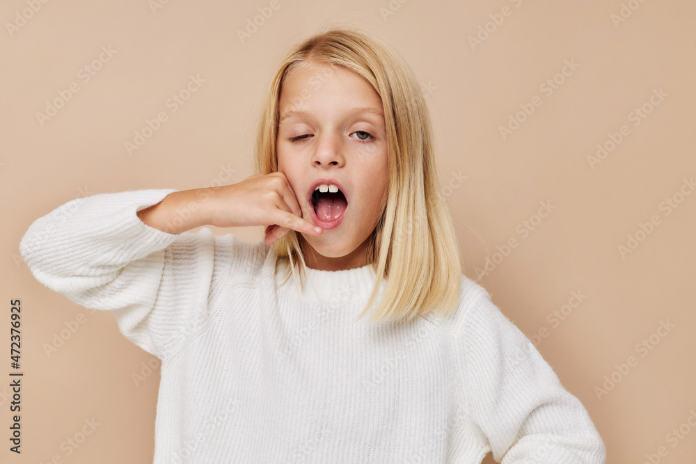 Positive little girl with blond hair posing studio Positive little girl with blond hair posing studio