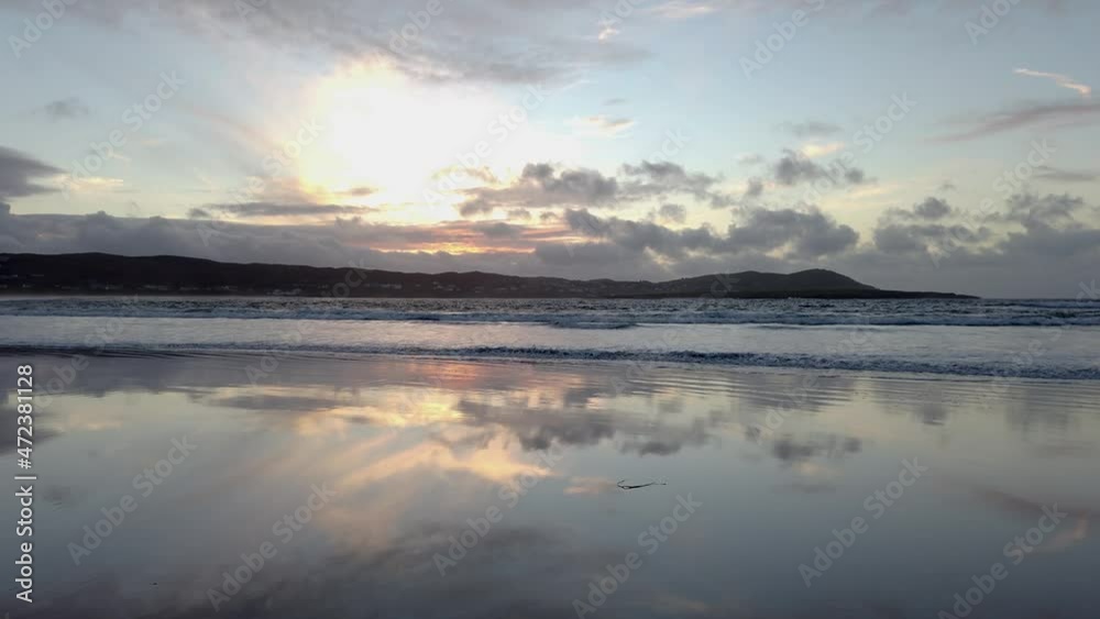 Dramatic sunset and waves at Narin Strand by Portnoo, County Donegal in Ireland. Dramatic sunset and waves at Narin Strand by Portnoo, County Donegal in Ireland.