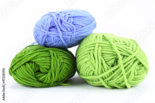 Multi-colored balls of wool on a white background. 