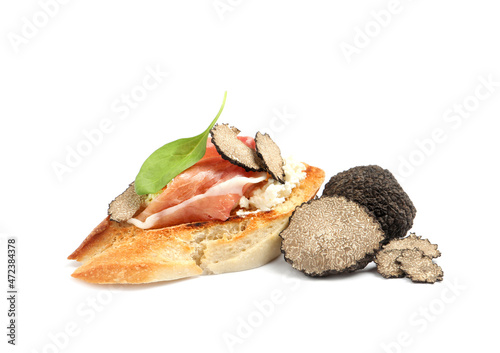 Tasty bruschetta with prosciutto and truffle on white background