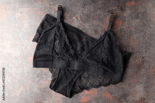 Black set of women's underwear on textured background © Atlas
