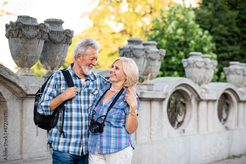 Happy senior couple of tourists in a city