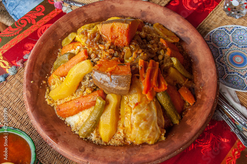 Tajine with vegetables. A tajine or tagine is a North African dish, named after the earthenware pot in which it is cooked. It is also called maraq or marqa.  photo