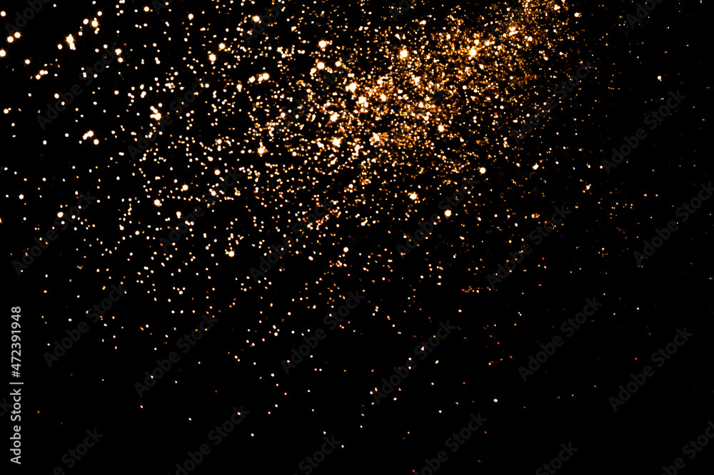 Gold glitter on black background. Christmas, new year, festive concept. Copy space
