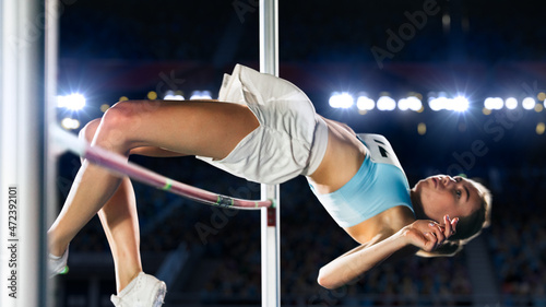 High Jump Championship: Professional Female Athlete on World Championship Successfully Jumping over Bar. Shot of Competition on Stadium with Sports Achievement Experience. Determination of Champion.
