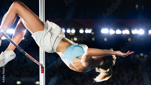 High Jump Championship: Professional Female Athlete on World Championship Successfully Jumping over Bar. Shot of Competition on Stadium with Sports Achievement Experience. Determination of Champion.