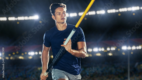 Pole Vault Jumping: Portrait of Professional Male Athlete on World Championship Running with Pole to Jump over Bar. Shot of Competition on Big Stadium with Sports Achievement Experience