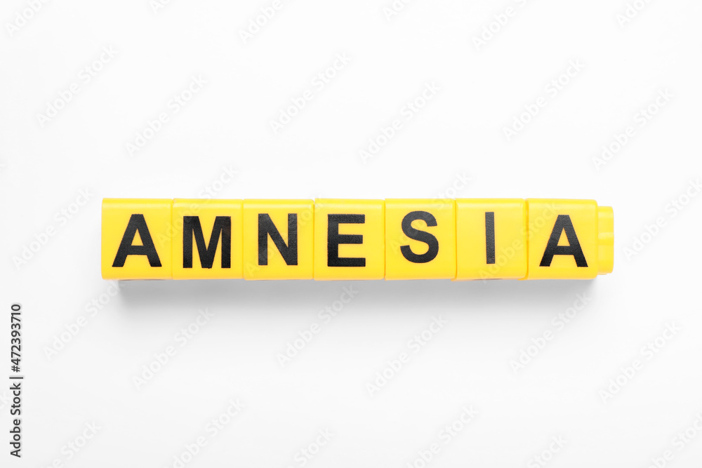 Yellow cubes with word Amnesia on white background, top view Yellow cubes with word Amnesia on white background, top view