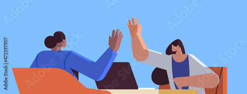 mix race businesspeople giving high five successful teamwork agreement concept portrait