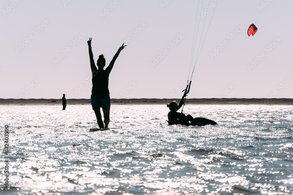 Naklejka premium Silhouette Of Happy And Excited Woman Holding Hands In The Air