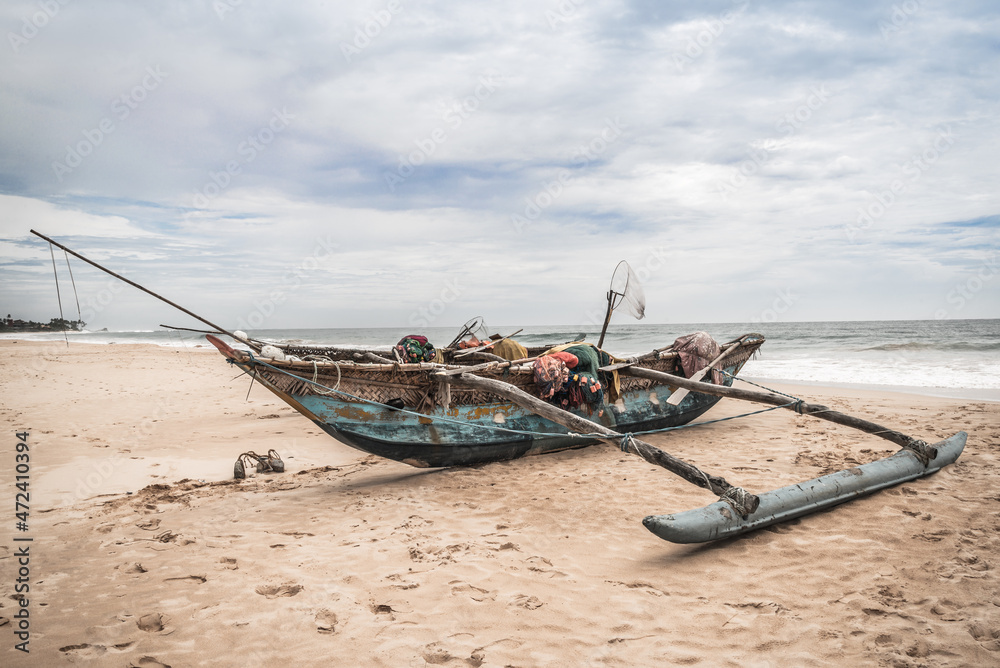 Fishing boat by the shore at Bentota Beach, Sri Lanka