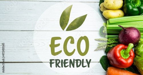 Overhead view of eco friendly symbol by fresh vegetables on white wooden table