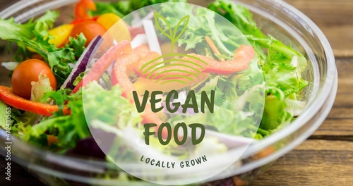 Close-up of vegan food locally grown symbol text against fresh salad in bowl