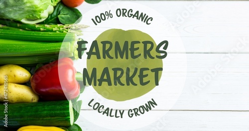 100 percent organic locally grown farmers market symbol text over fresh vegetables on wooden table