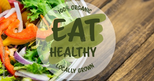 Eat healthy 100 percent organic locally grown symbol on fresh salad on table