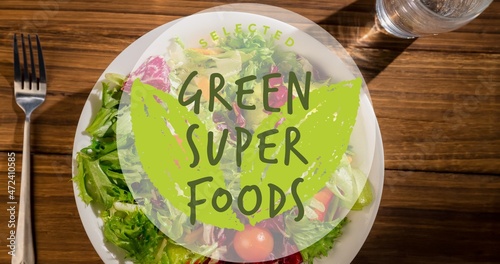 Directly above view of green super foods symbol text on fresh salad in plate