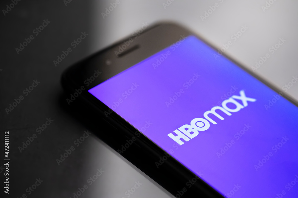 Smartphone on black surface displaying HBO max logo Stock Photo | Adobe ...