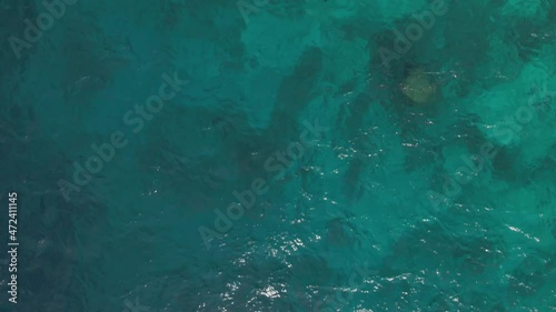 Drone view fly over beautiful turquoise ocean in tropical islands. Aerial shot of deep blue waters and calm waves of Maldives island. Concept of trip