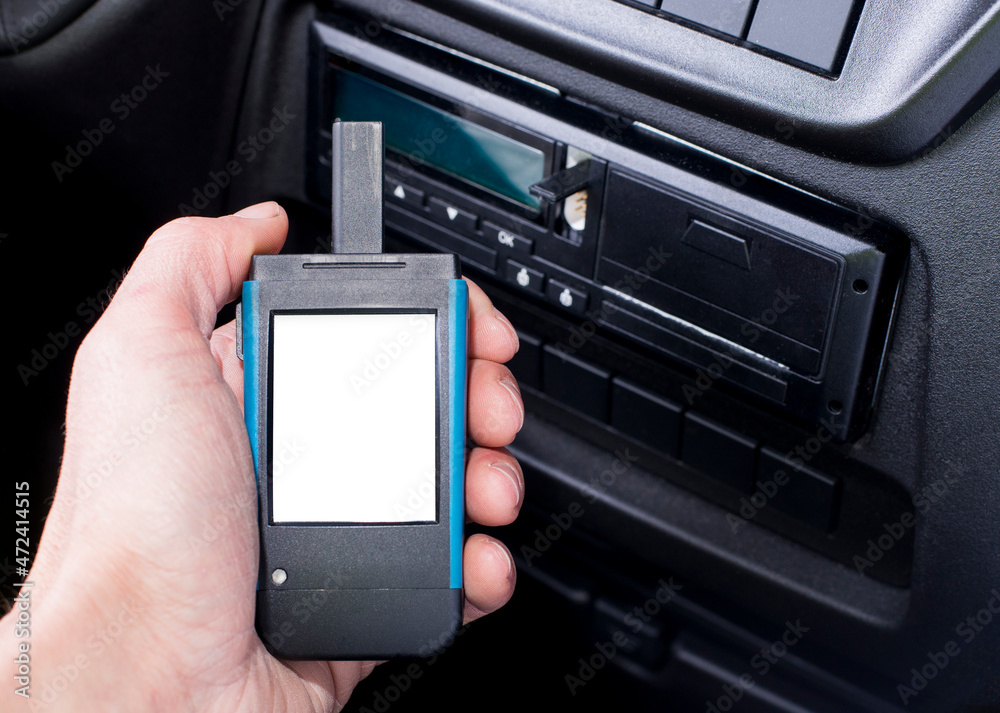 Driver holding a digital tachograph reader with isolated white screen