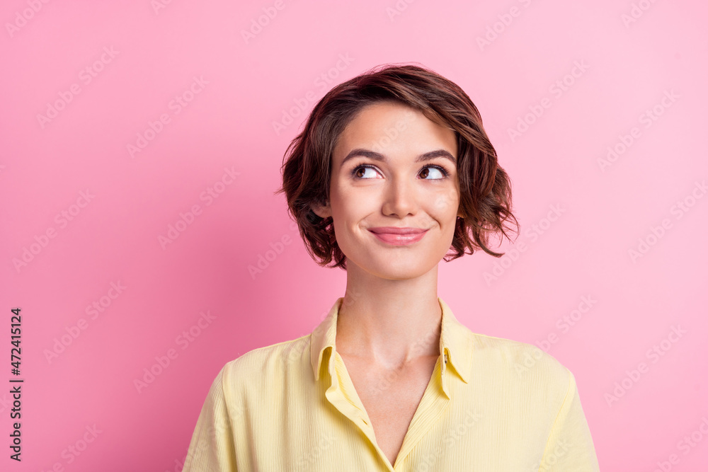 Photo of cute millennial brunette lady look up wear yellow shirt isolated on pink color background Photo of cute millennial brunette lady look up wear yellow shirt isolated on pink color background