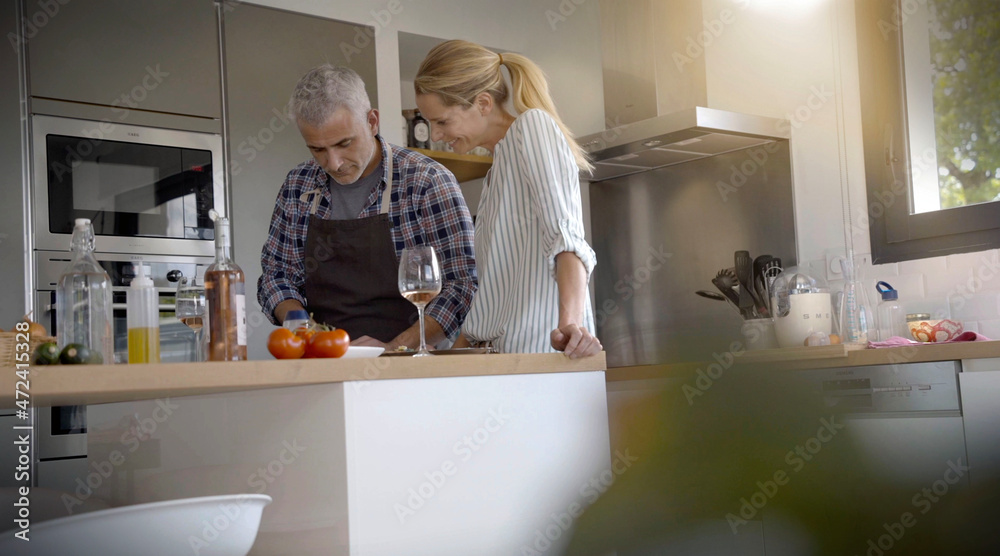 Fototapeta premium couple preparing meal in home kitchen