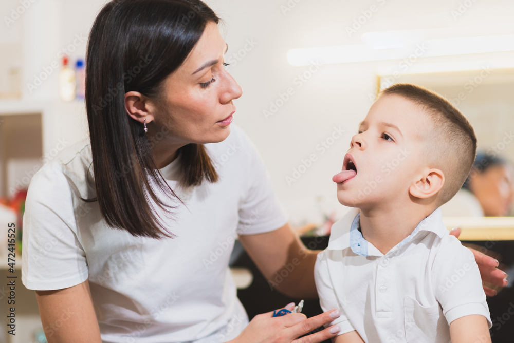 A woman speech therapist deals with the child and teaches him the correct pronunciation and competent speech. A woman speech therapist deals with the child and teaches him the correct pronunciation and competent speech.