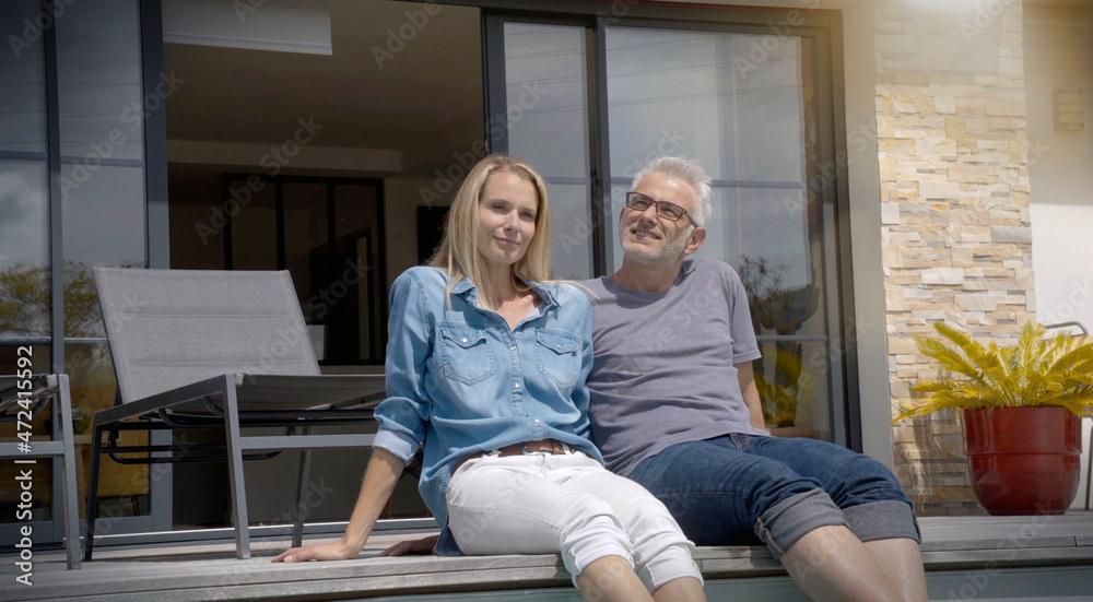 couple relaxing on the terrace of the house couple relaxing on the terrace of the house