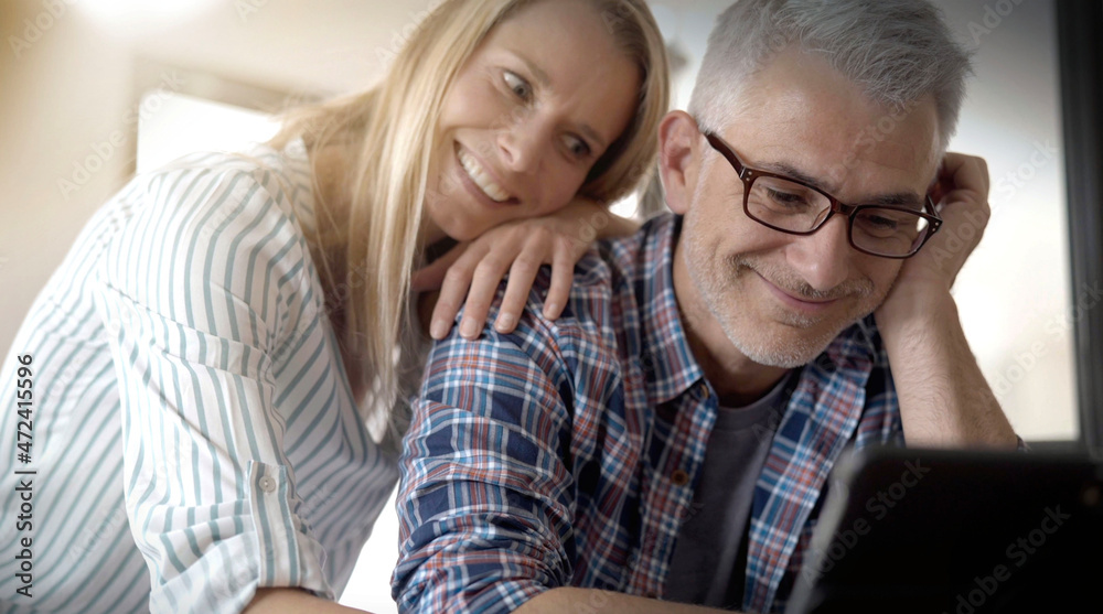 couple consulting internet on a tablet couple consulting internet on a tablet