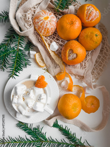 Christmas still life. Tangerines and heart shaped marshmallow slices with latte coffee