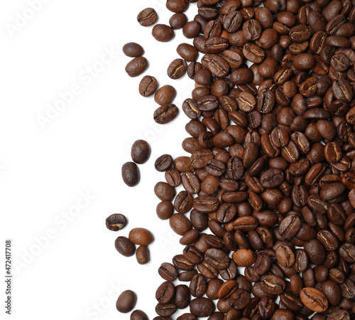 Many roasted coffee beans on white background, top view