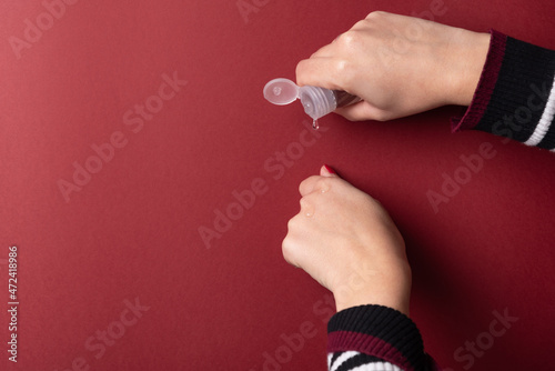 Feminine hands putting gel on fist