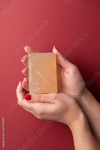 Feminine hands showing soap on copy space