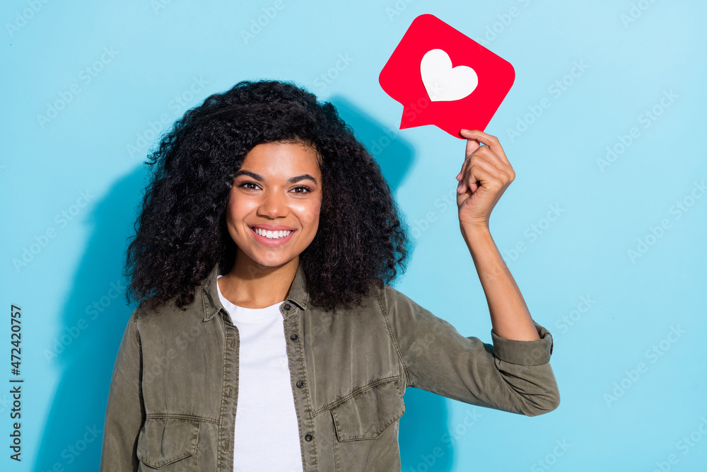 Photo of young pretty girl hold reaction icon share repost comment popular click isolated over blue color background Photo of young pretty girl hold reaction icon share repost comment popular click isolated over blue color background