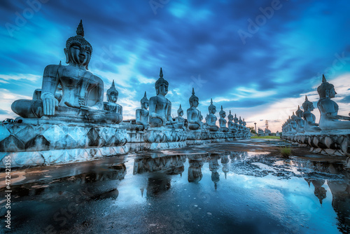 Many Statue buddha image at sunset in southen of Thailand. Blue tone