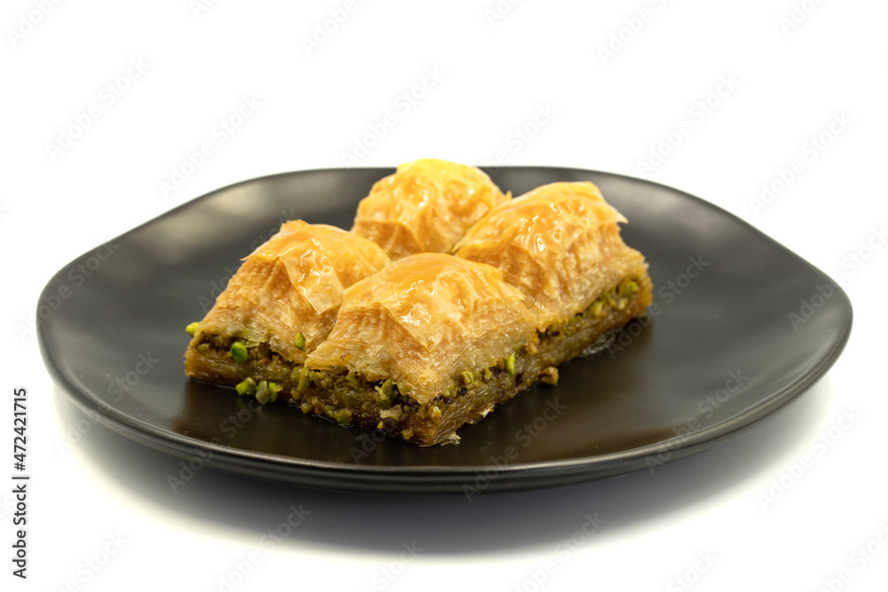 Pistachio baklava isolated on a white background. Turkish style pistachio baklava presentation and service. Horizontal view. close up