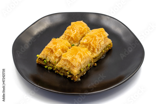 Pistachio baklava isolated on a white background. Turkish style pistachio baklava presentation and service. Horizontal view. close up