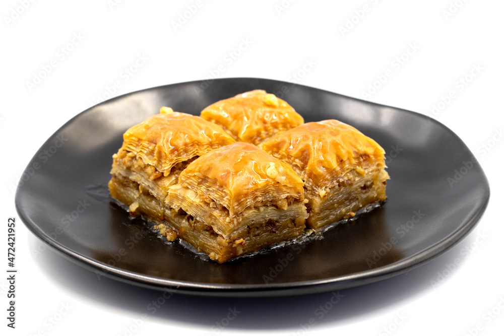 Walnuts baklava isolated on a white background. Turkish style walnut baklava presentation and service. Horizontal view. close up Walnuts baklava isolated on a white background. Turkish style walnut baklava presentation and service. Horizontal view. close up