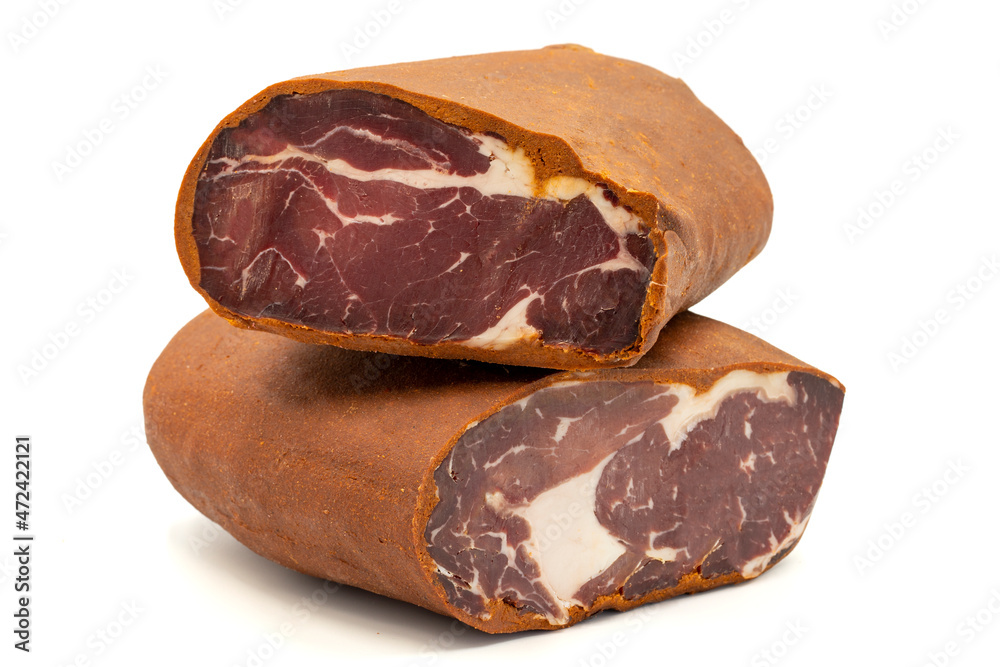 Turkish pastrami on a white background. Bacon made from veal. Turkish bacon, pastrami (Kayseri pastirma). Horizontal view. close up Turkish pastrami on a white background. Bacon made from veal. Turkish bacon, pastrami (Kayseri pastirma). Horizontal view. close up