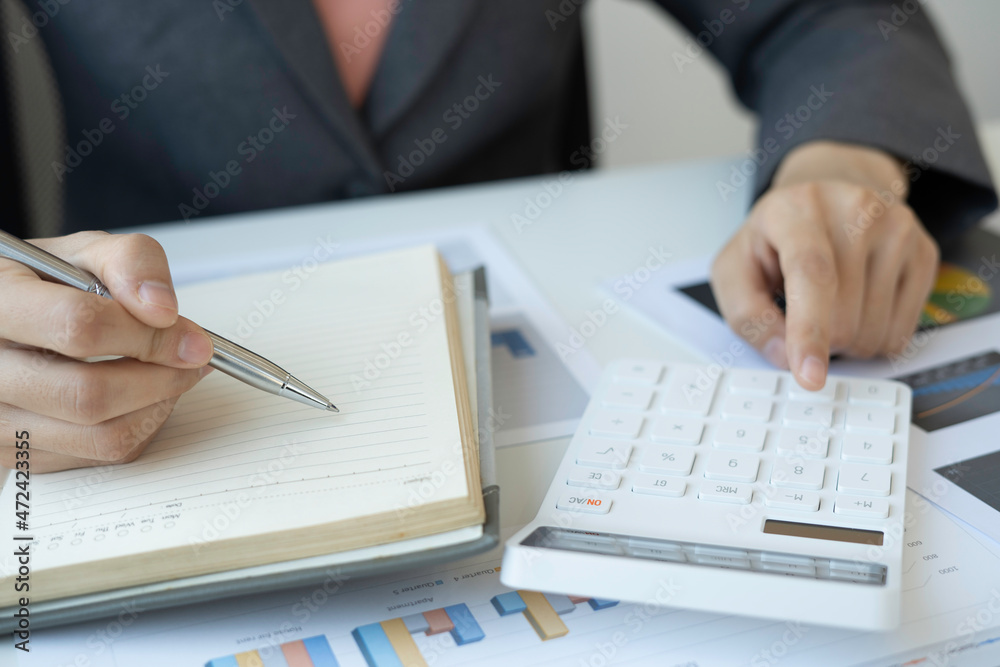 Accounting businesswomen are calculating tax and income-expenditure and analyzing real estate investment data, Dedicated to the progress and growth of the company, Financial and tax systems concept. Accounting businesswomen are calculating tax and income-expenditure and analyzing real estate investment data, Dedicated to the progress and growth of the company, Financial and tax systems concept.