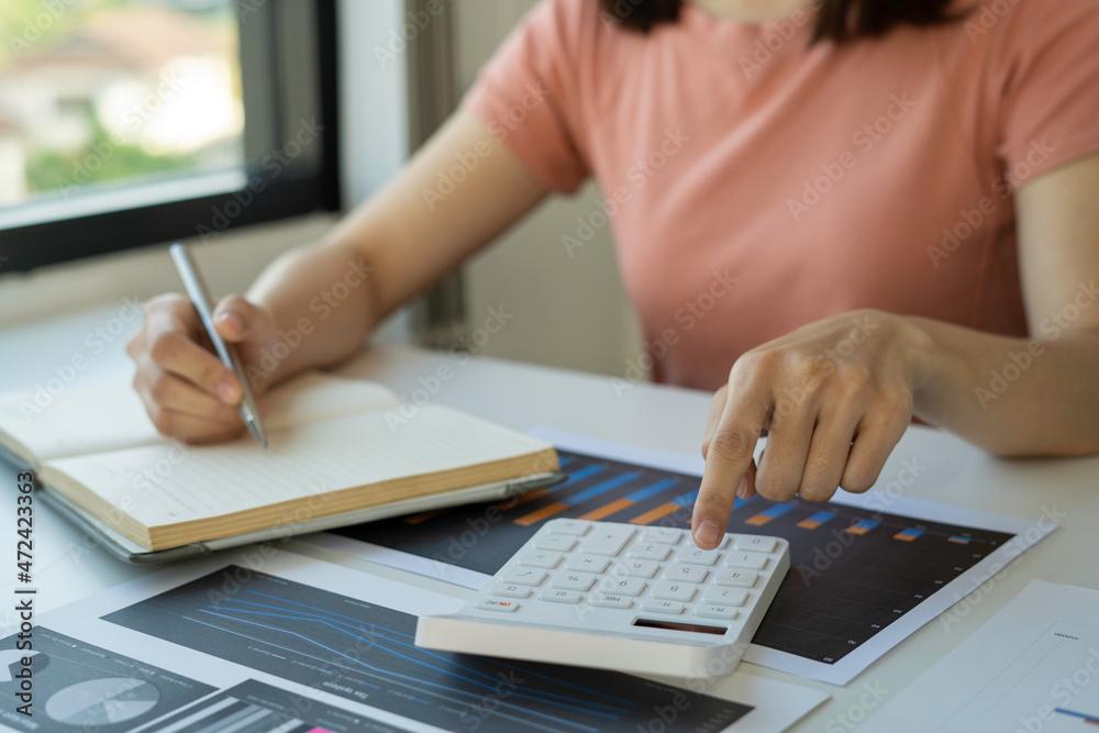 Accounting businesswomen are calculating tax and income-expenditure and analyzing real estate investment data, Dedicated to the progress and growth of the company, Financial and tax systems concept. Accounting businesswomen are calculating tax and income-expenditure and analyzing real estate investment data, Dedicated to the progress and growth of the company, Financial and tax systems concept.