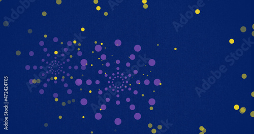 Image of purple firework explosions and bokeh yellow light spots on blue background