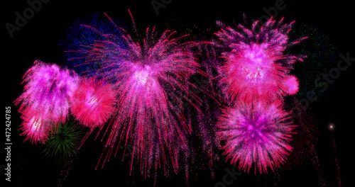 Image of colourful christmas and new year fireworks exploding in night sky