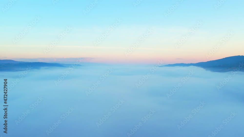 4K Drone Flying through the clouds at dusk or dawn. Aerial top cloudscape view from drone. Tropical forest with smoke and fog.
4K Drone Flying through the clouds at dusk or dawn. Aerial top cloudscape view from drone. Tropical forest with smoke and fog.
