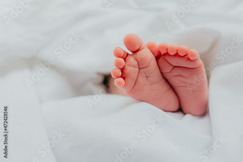 Baby's feet under a white blanket