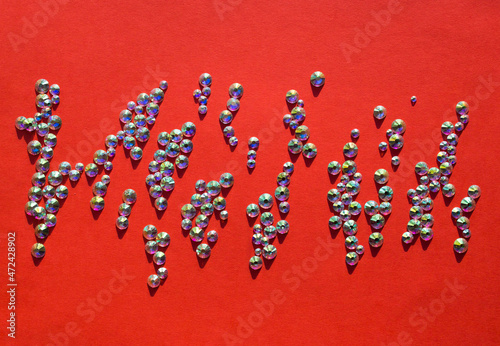 rhinestones on a red background, top photo. design for text