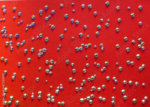 rhinestones on a red background, top photo. design for text